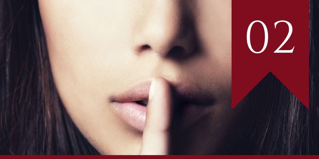 Episode 2 - a cropped photo of a woman with dark hair holding a finger to her lips 