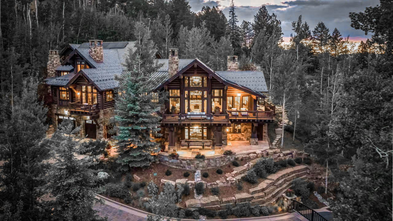 Hale House A rustic log cabin mansion sitting in a forest